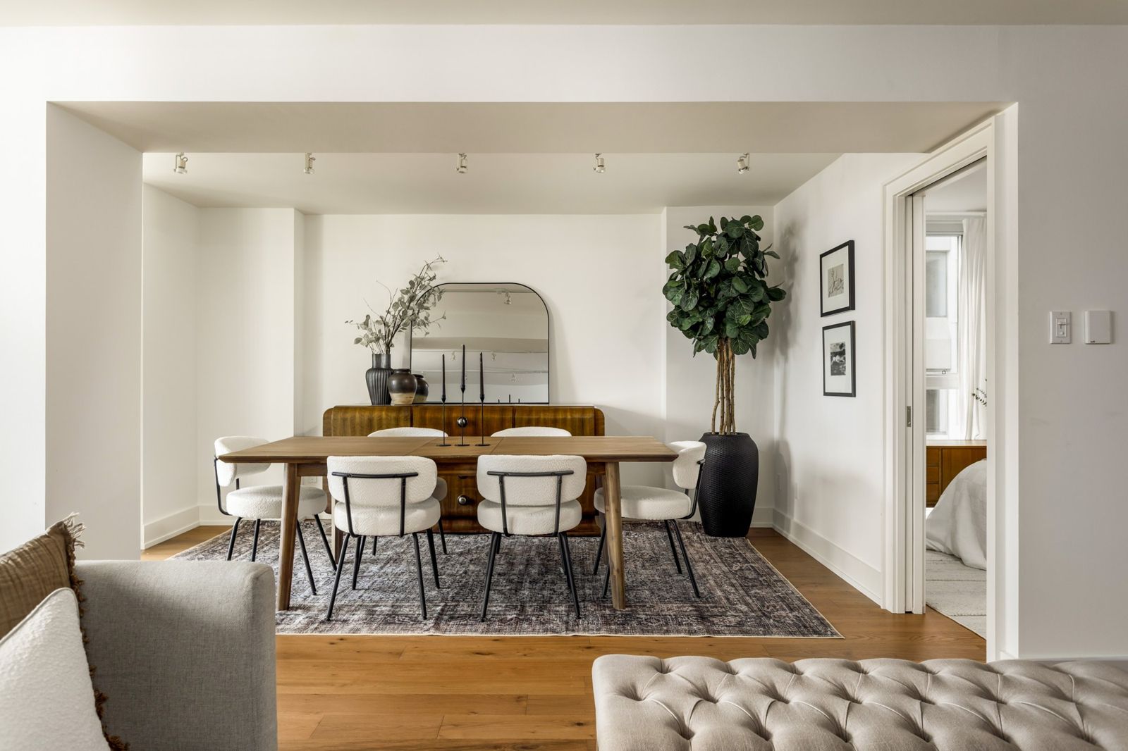 Dining room with an arched mirror, walnut sideboard and the original art, Bloor Street East