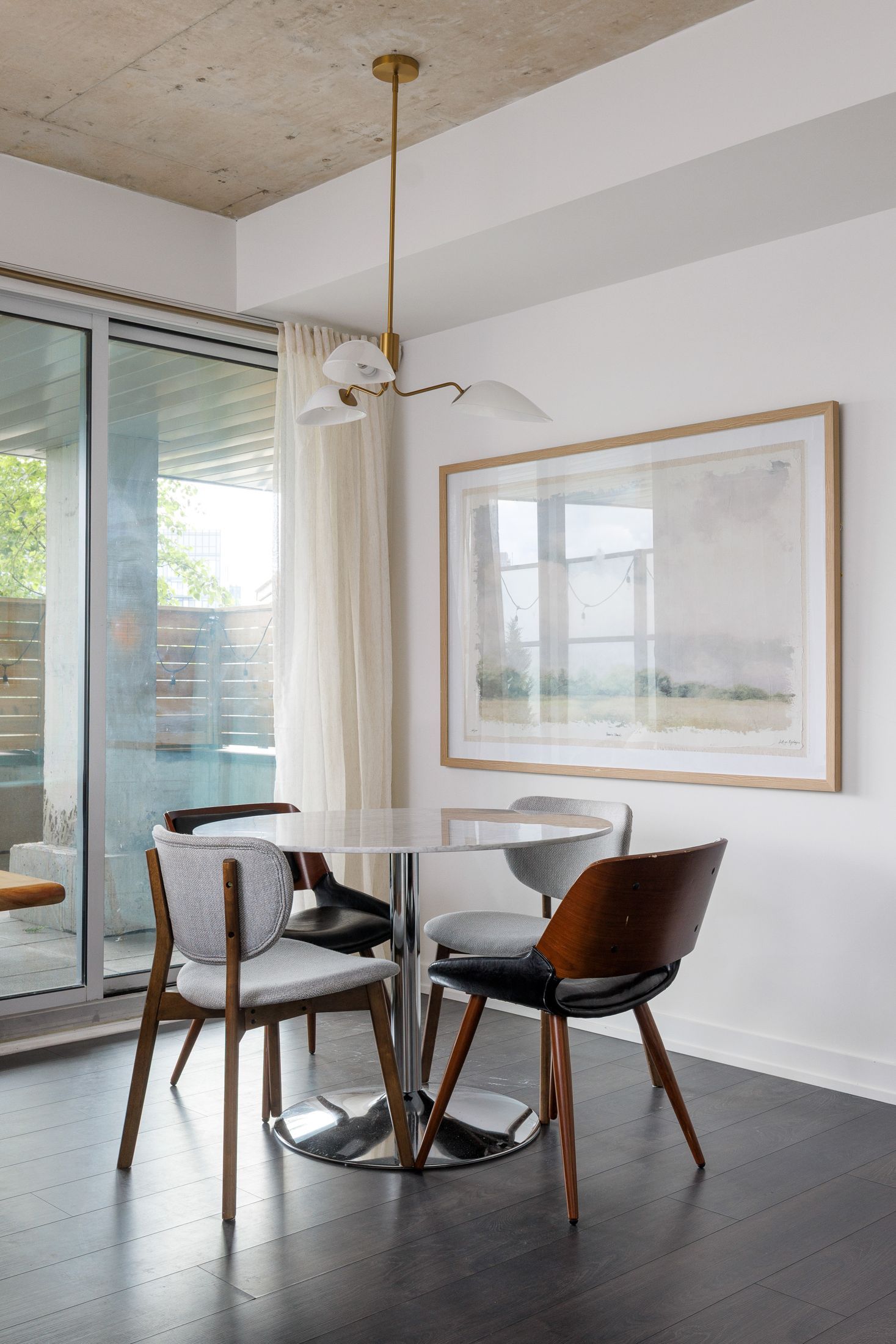 Dining zone with a round table beside the balcony