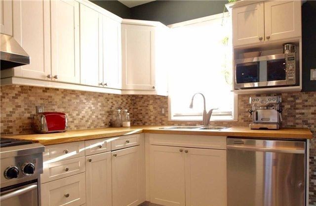 Before: a closed galley kitchen with a wood counter and a small pass-through