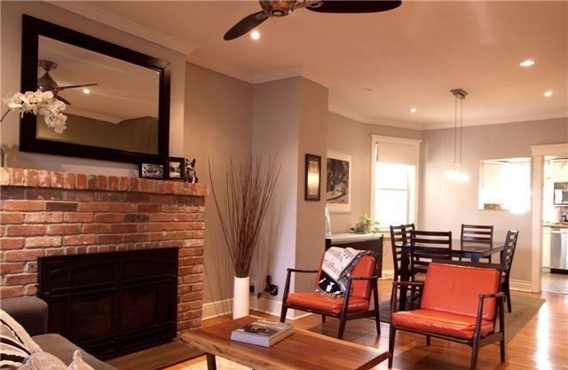 Before: a dark brick fireplace wall and a closed-off sitting room