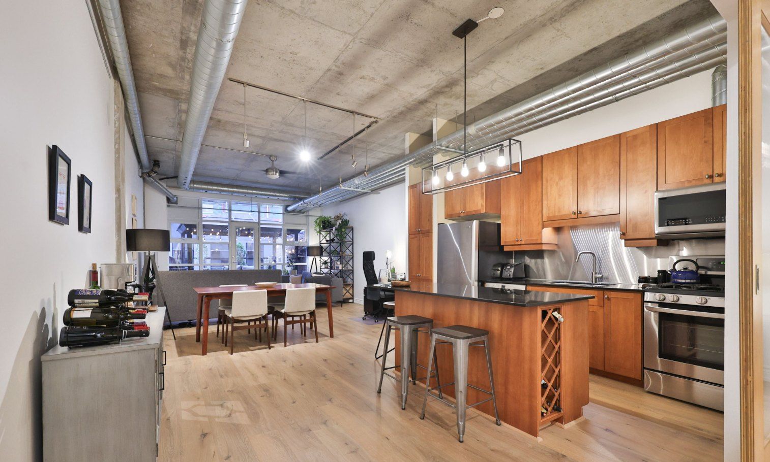 Before: underscaled furniture and small pendants in the loft