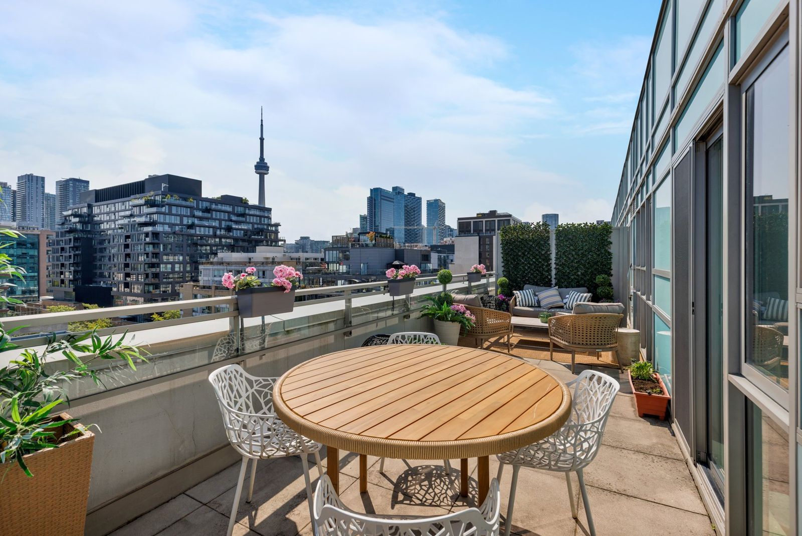 The terrace zoned for dining and lounging, with the CN Tower beyond